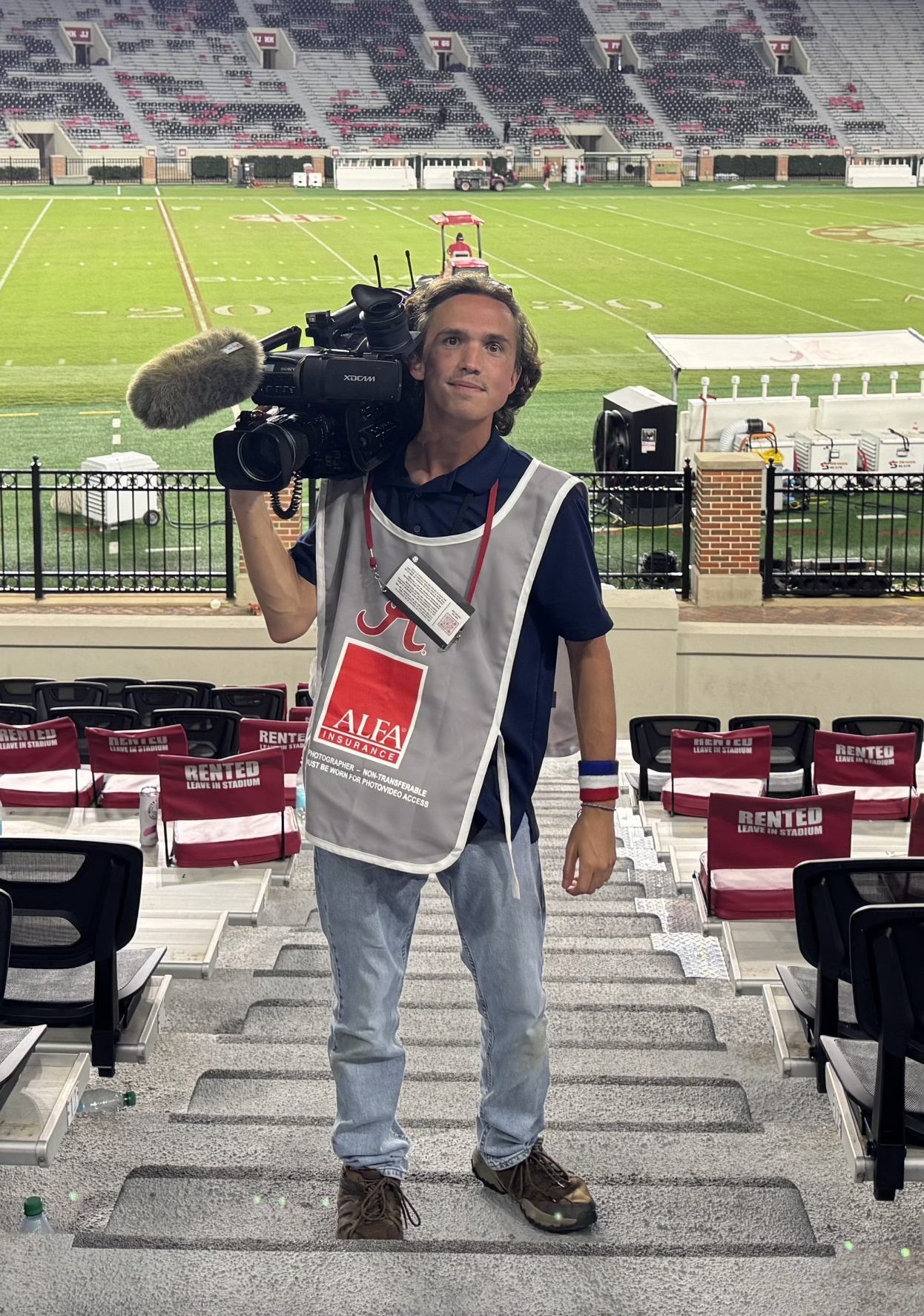 Man with video camera at football stadium