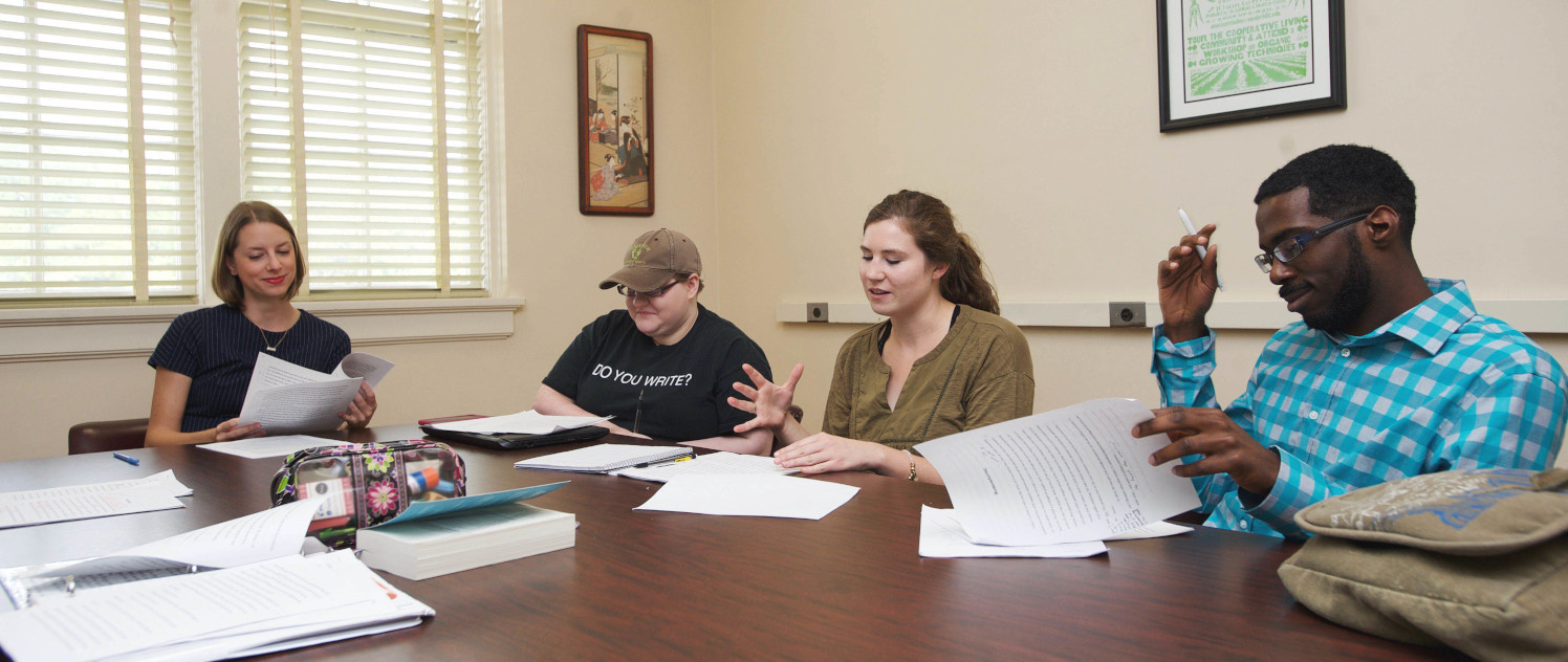 Students seating at a discussion table during a Creative Writing Class