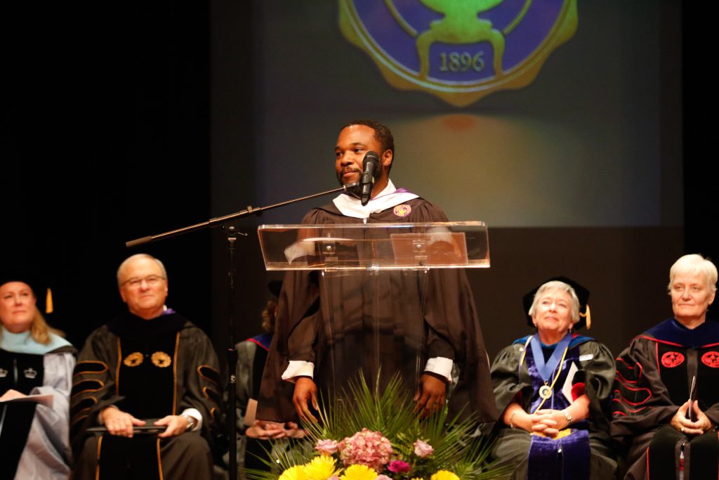UMNAA President Eddie Baker III '04 addresses the audience during Founders' Day convocation.