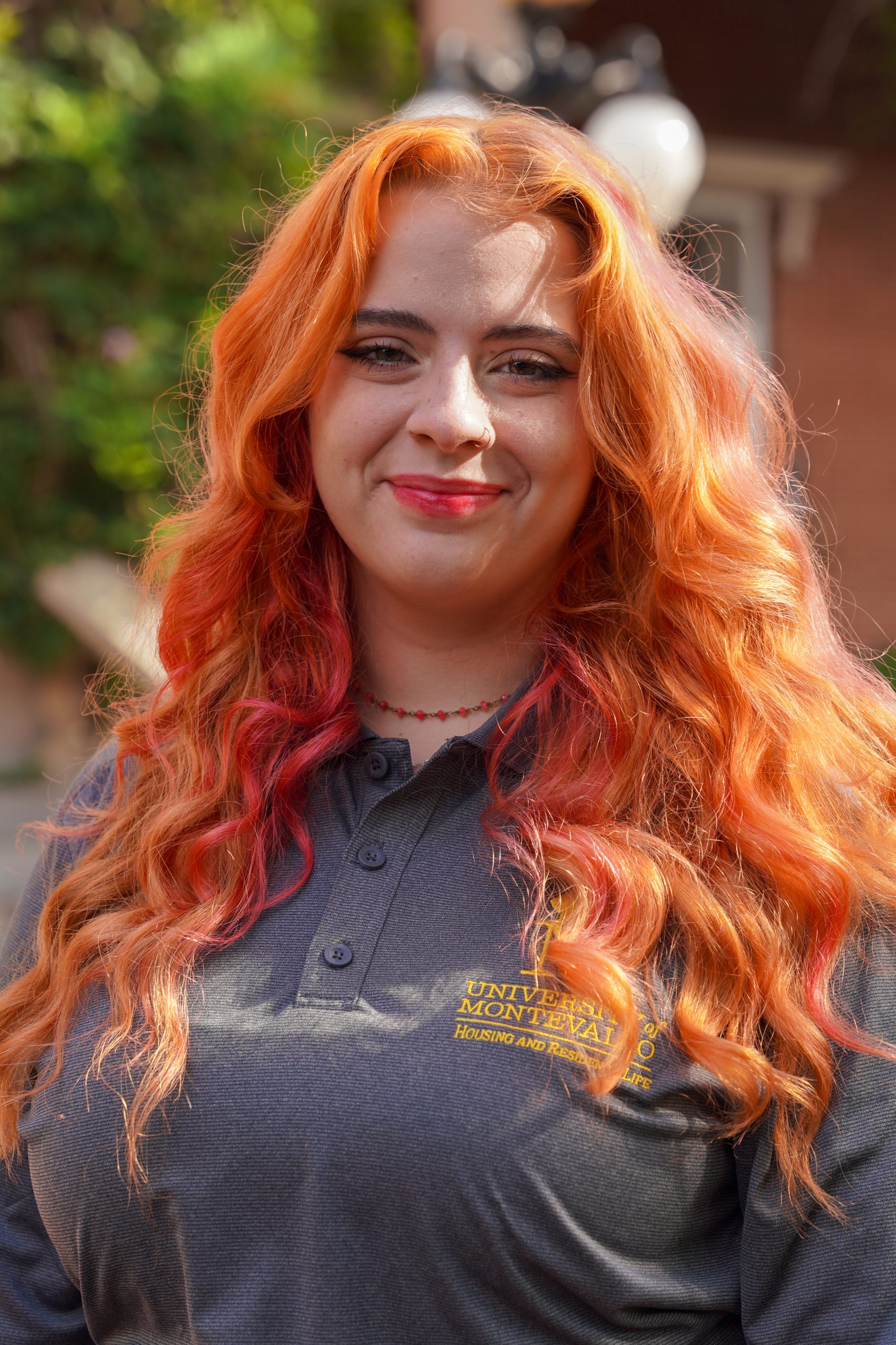 Headshot of Jordan Armstrong - female in grey shirt with red hair