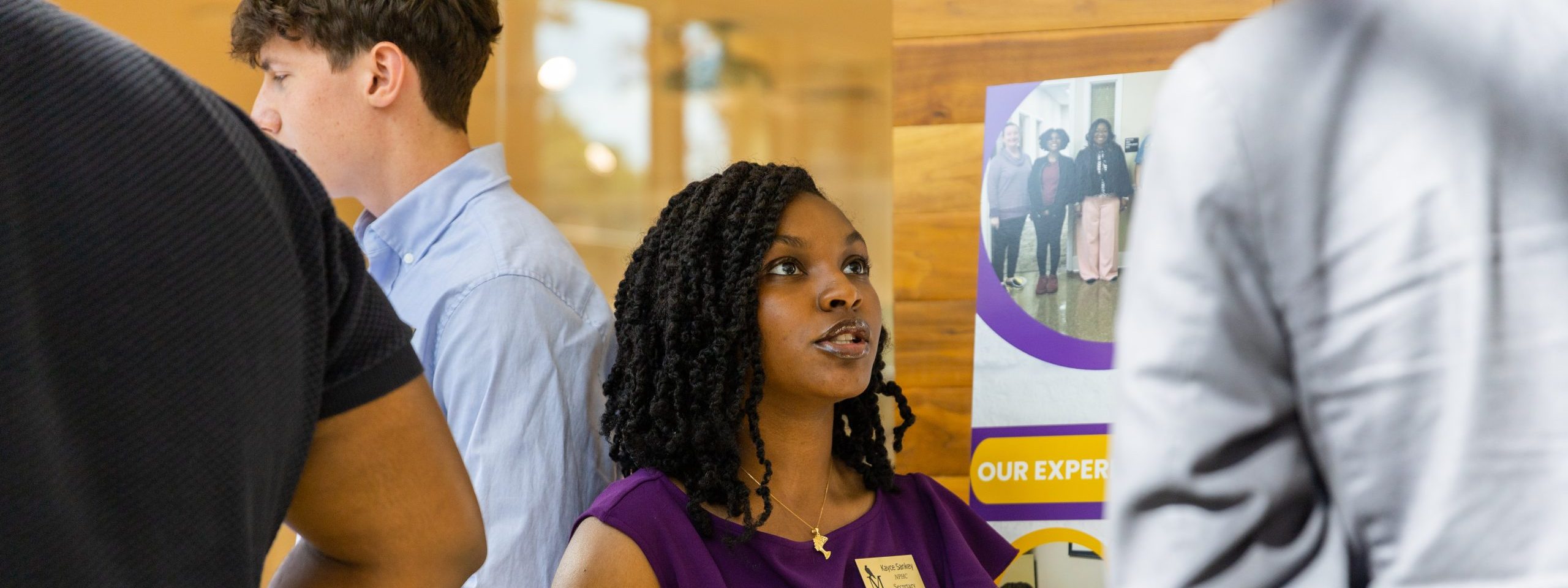 A student presents their poster at the Falcon Scholars in Action Showcase