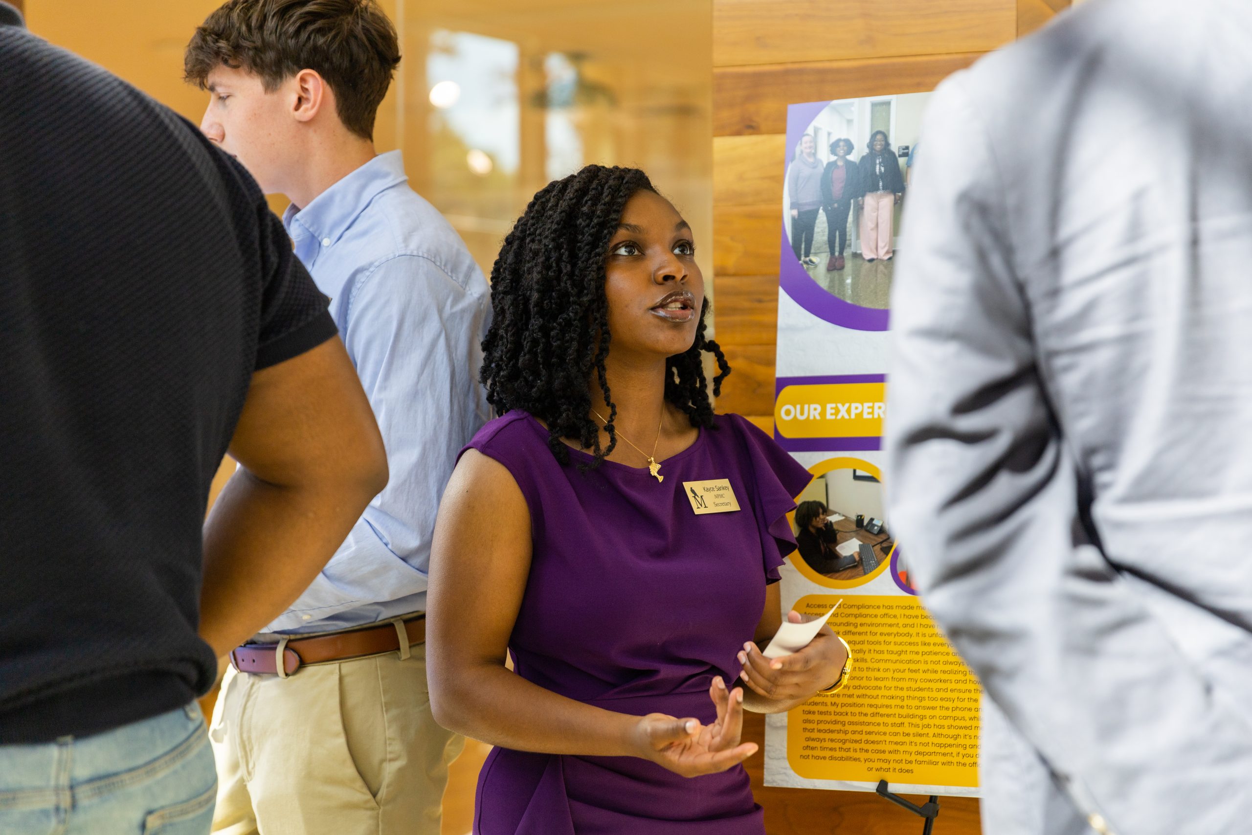 A student presents their poster at the Falcon Scholars in Action Showcase