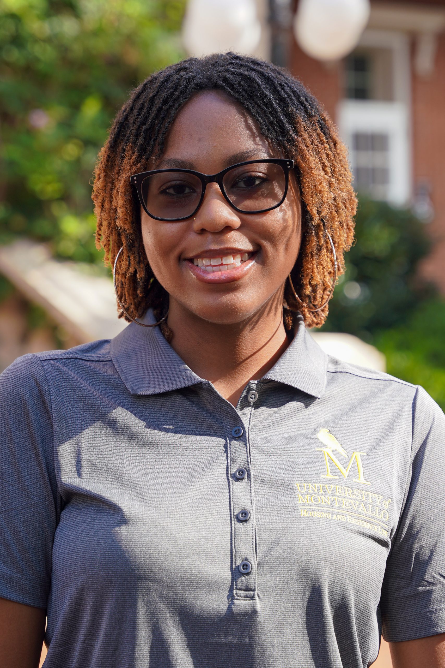 Headshot of Aspen Mays - female with brown hair and eyeglasses