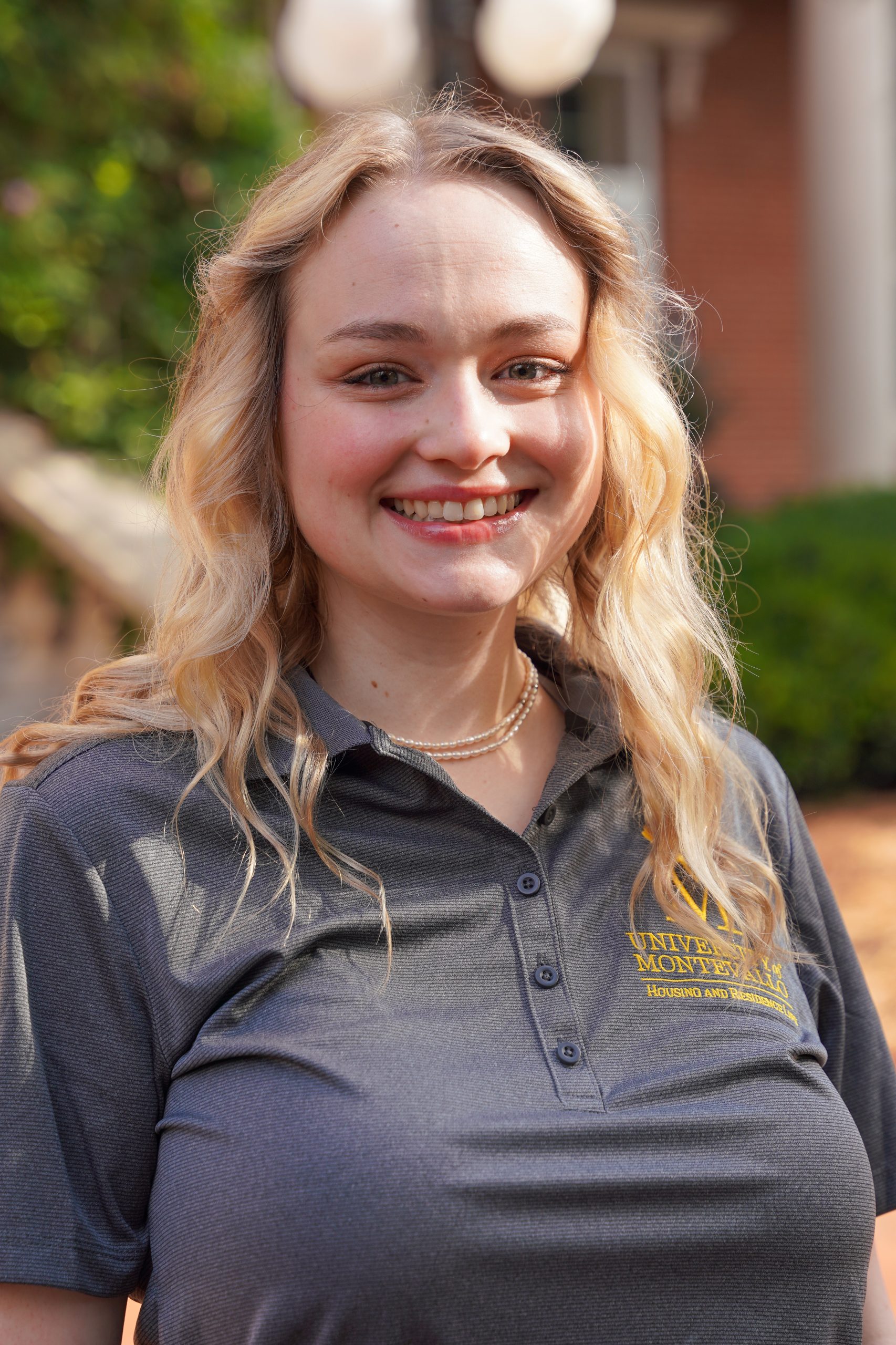 Headshot of Laura McCallion - female in grey shirt with blonde hair
